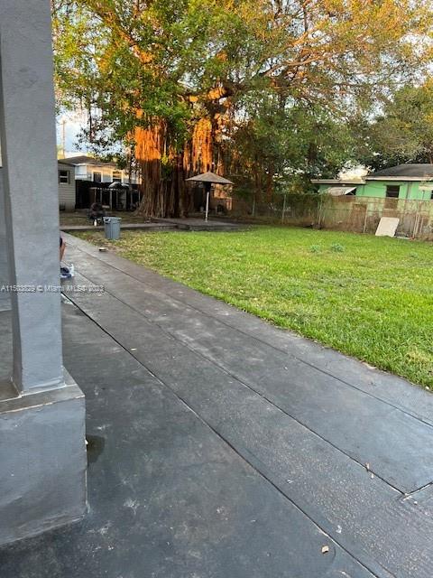 1755 Northwest 69th Street Miami, FL 33147 - Photo 32 of 36 a view of a swimming pool and trees in the background