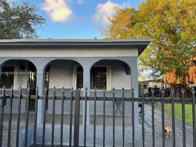 1755 Northwest 69th Street Miami, FL 33147 - Photo 9 of 36 a view of a tiny house with wooden fence