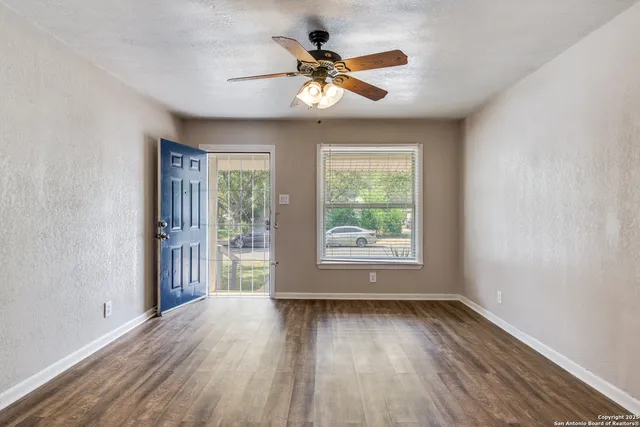wooden floor in an empty room with a window