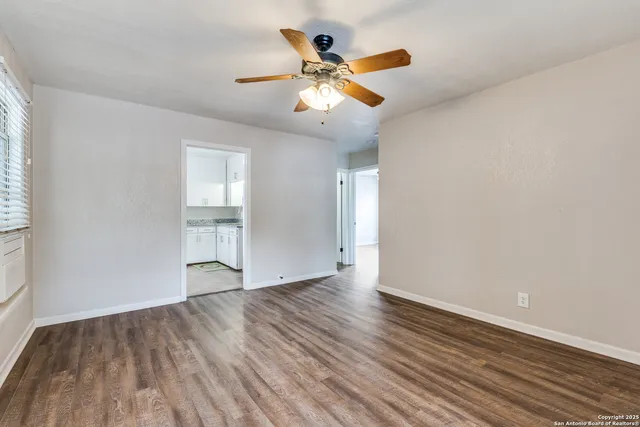 wooden floor in an empty room with a window