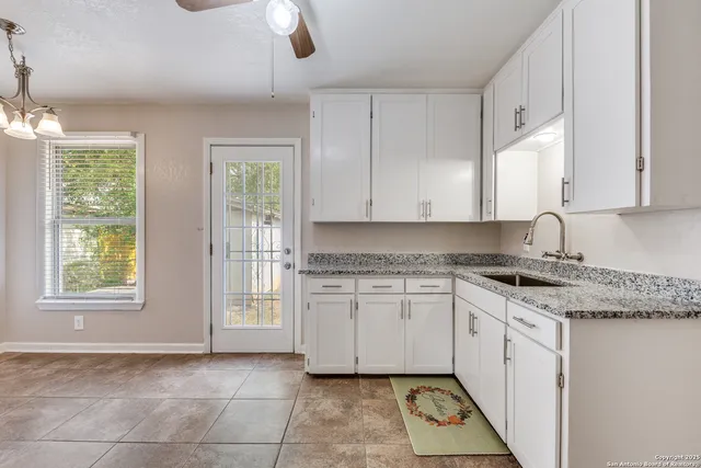 a kitchen with stainless steel appliances granite countertop a stove a sink and a granite counter tops