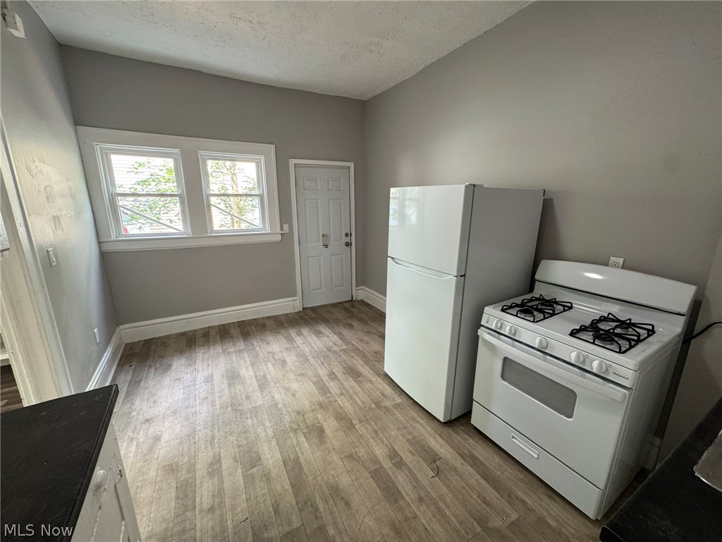 674-676 Carlysle Street Akron, OH 44310 - Photo 10 of 20 Kitchen space featuring wood-finish flooring and light gray walls