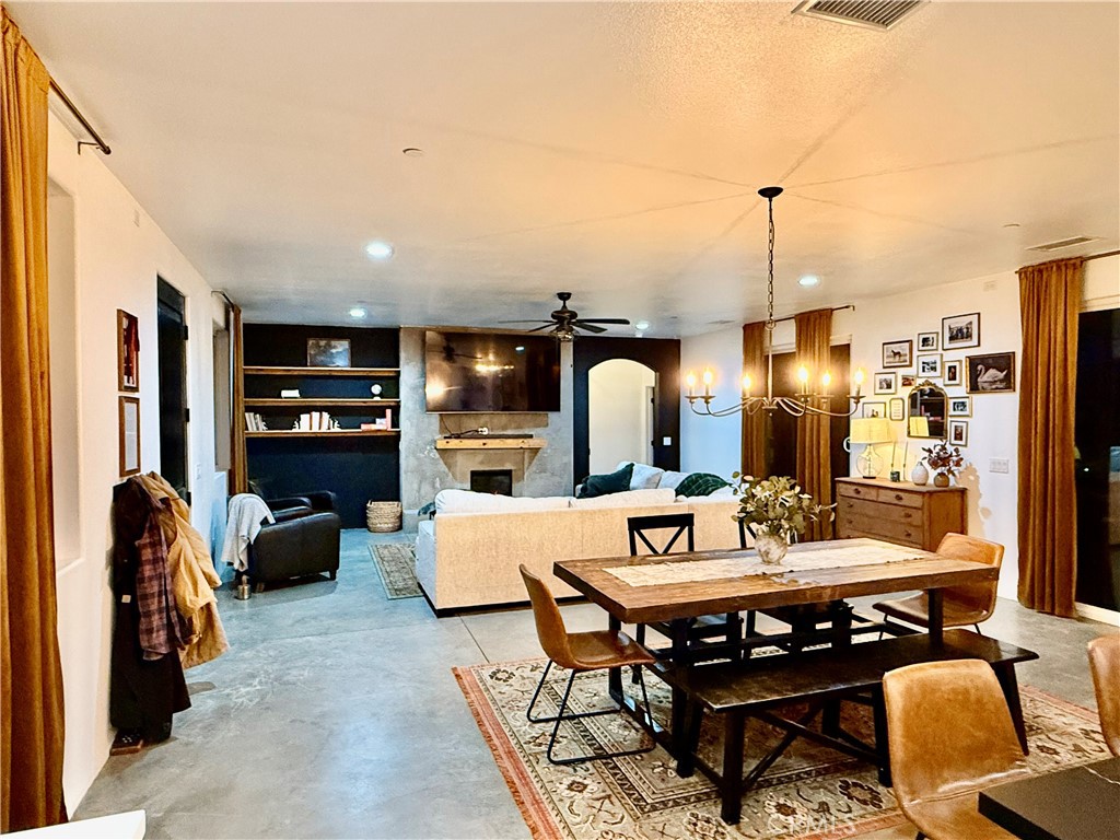 10773 Mills Road Apple Valley, CA 92308 - Photo 11 of 39 a living room with furniture a rug and a chandelier