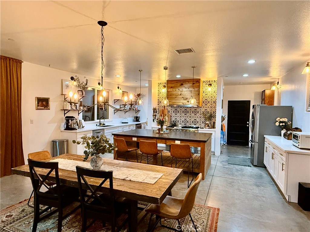 10773 Mills Road Apple Valley, CA 92308 - Photo 12 of 39 a view of dining table chairs and kitchen view