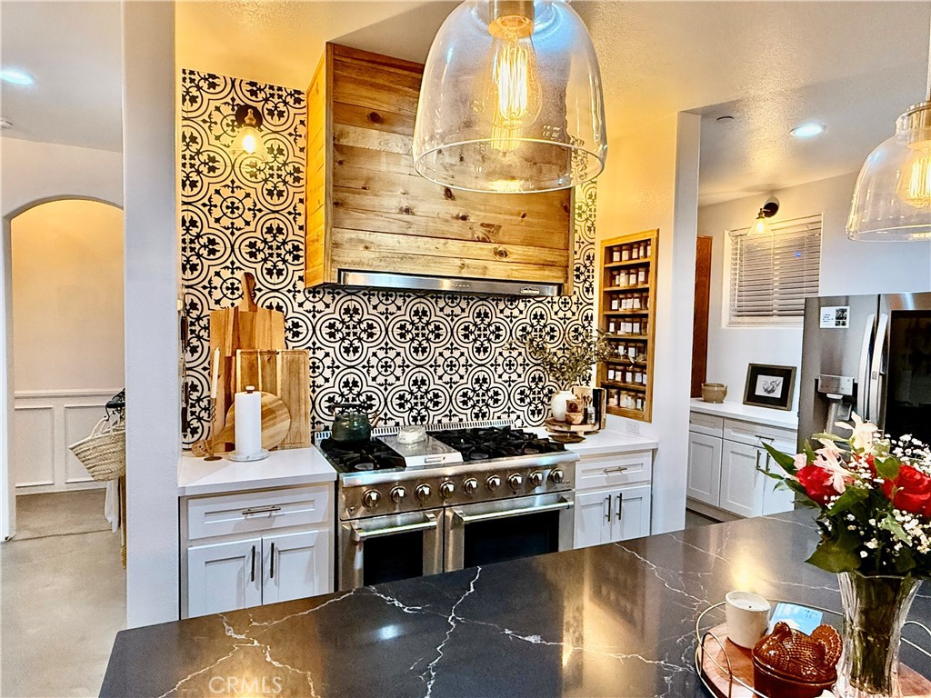 10773 Mills Road Apple Valley, CA 92308 - Photo 14 of 39 a kitchen with stainless steel appliances kitchen island granite countertop a stove and a refrigerator