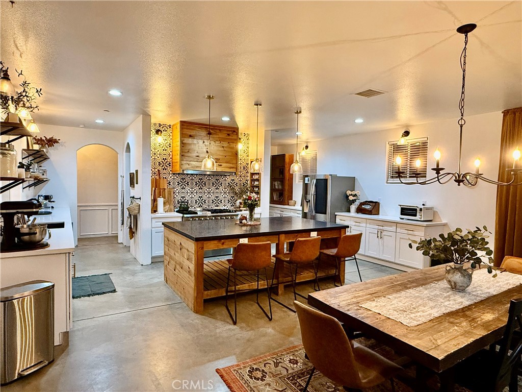 10773 Mills Road Apple Valley, CA 92308 - Photo 15 of 39 a large kitchen with a table and chairs