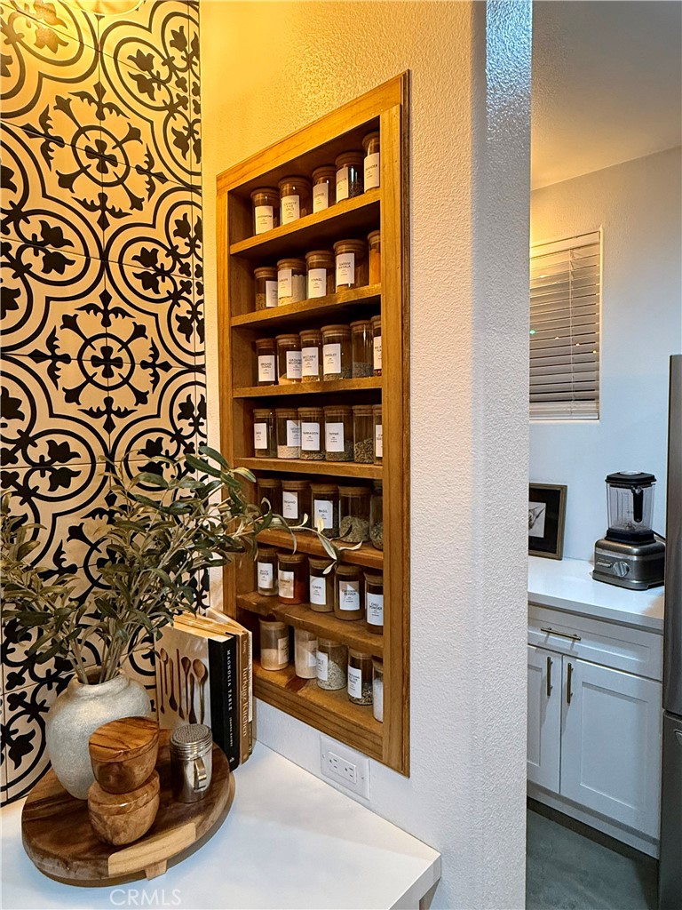 10773 Mills Road Apple Valley, CA 92308 - Photo 17 of 39 a view of a kitchen with a fireplace and cabinets