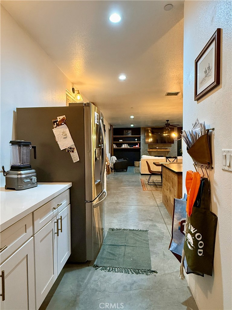10773 Mills Road Apple Valley, CA 92308 - Photo 19 of 39 a kitchen with stainless steel appliances kitchen island granite countertop a refrigerator and a stove