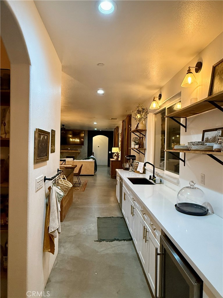10773 Mills Road Apple Valley, CA 92308 - Photo 20 of 39 a large white kitchen with a sink and breakfast area