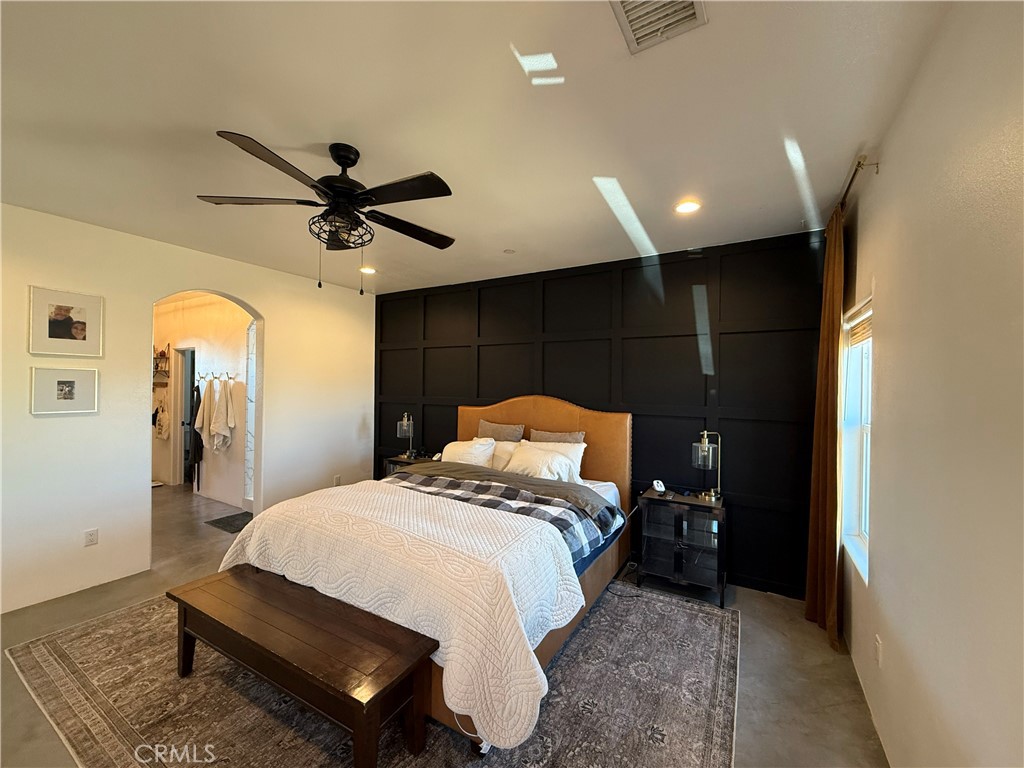 10773 Mills Road Apple Valley, CA 92308 - Photo 34 of 39 a bed room with a bed and a ceiling fan