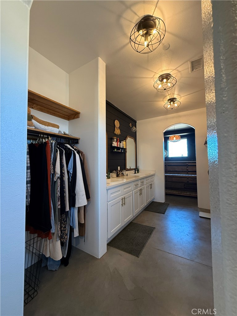 10773 Mills Road Apple Valley, CA 92308 - Photo 36 of 39 a hallway with a large mirror and cabinets