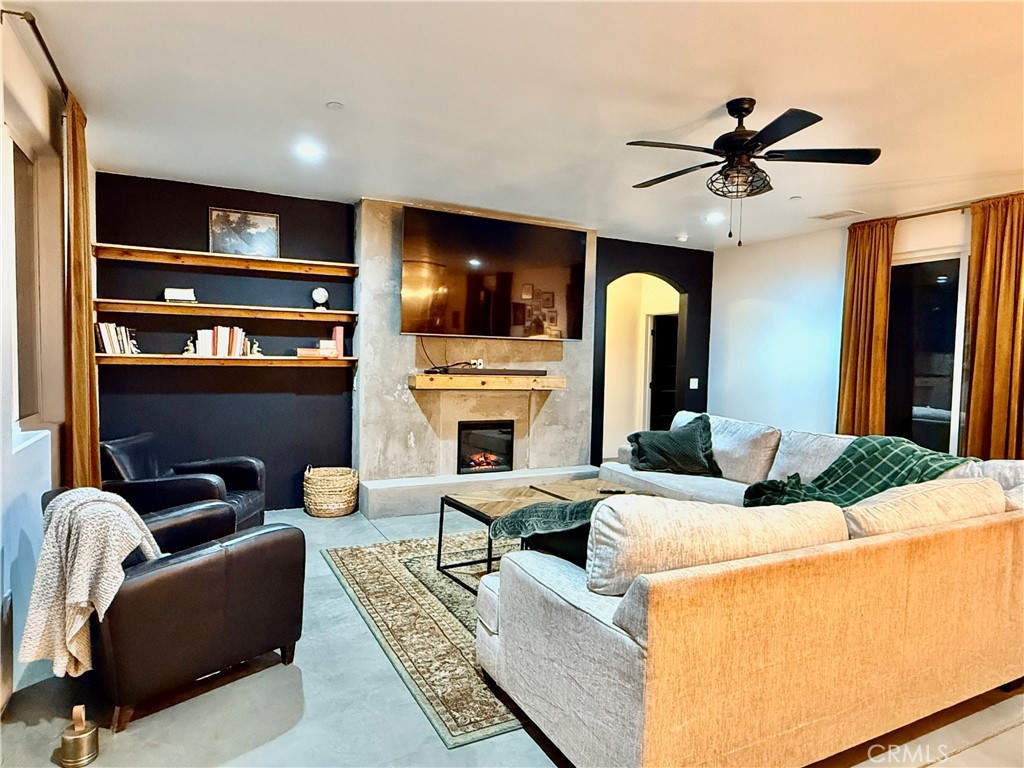 10773 Mills Road Apple Valley, CA 92308 - Photo 6 of 39 a living room with fireplace furniture and a flat screen tv