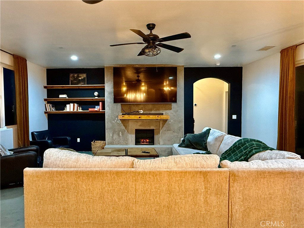 10773 Mills Road Apple Valley, CA 92308 - Photo 7 of 39 a living room with fireplace furniture and a flat screen tv