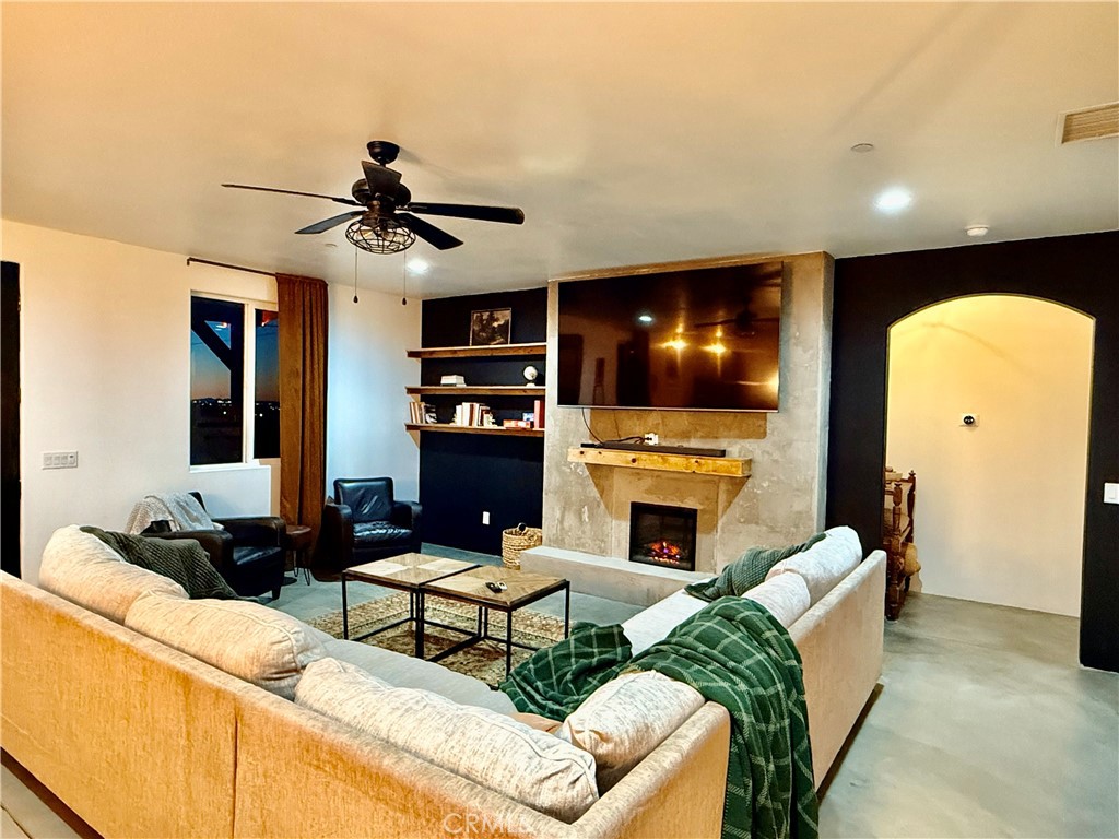 10773 Mills Road Apple Valley, CA 92308 - Photo 8 of 39 a living room with furniture and a fireplace