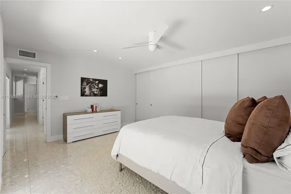 a bedroom with a bed and a couch
