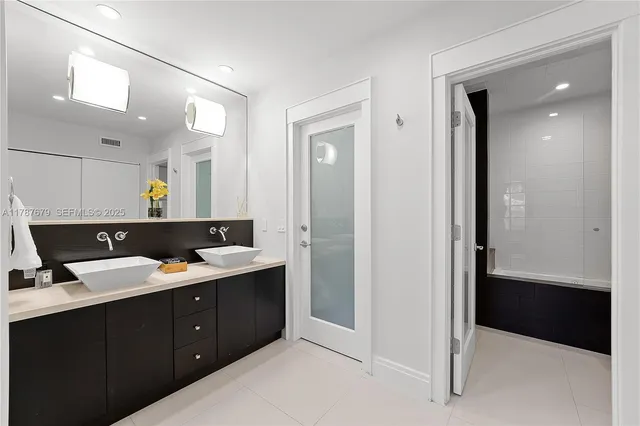 a bathroom with a double vanity sink and mirror