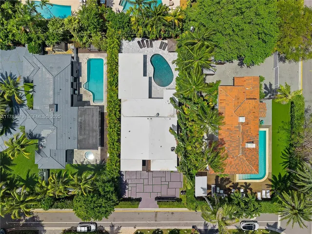 an aerial view of a house with garden space and street view
