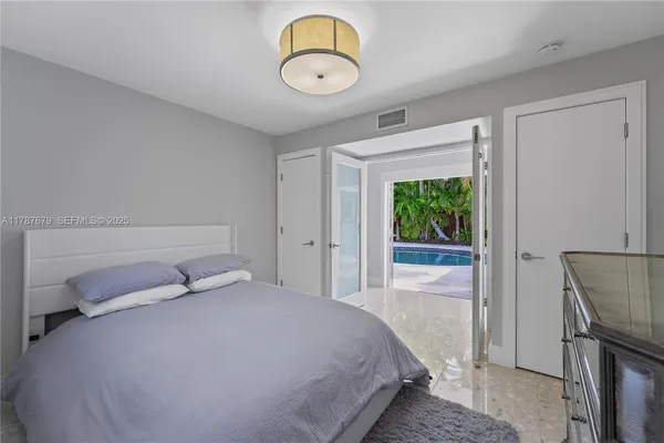 a bedroom with a bed and window