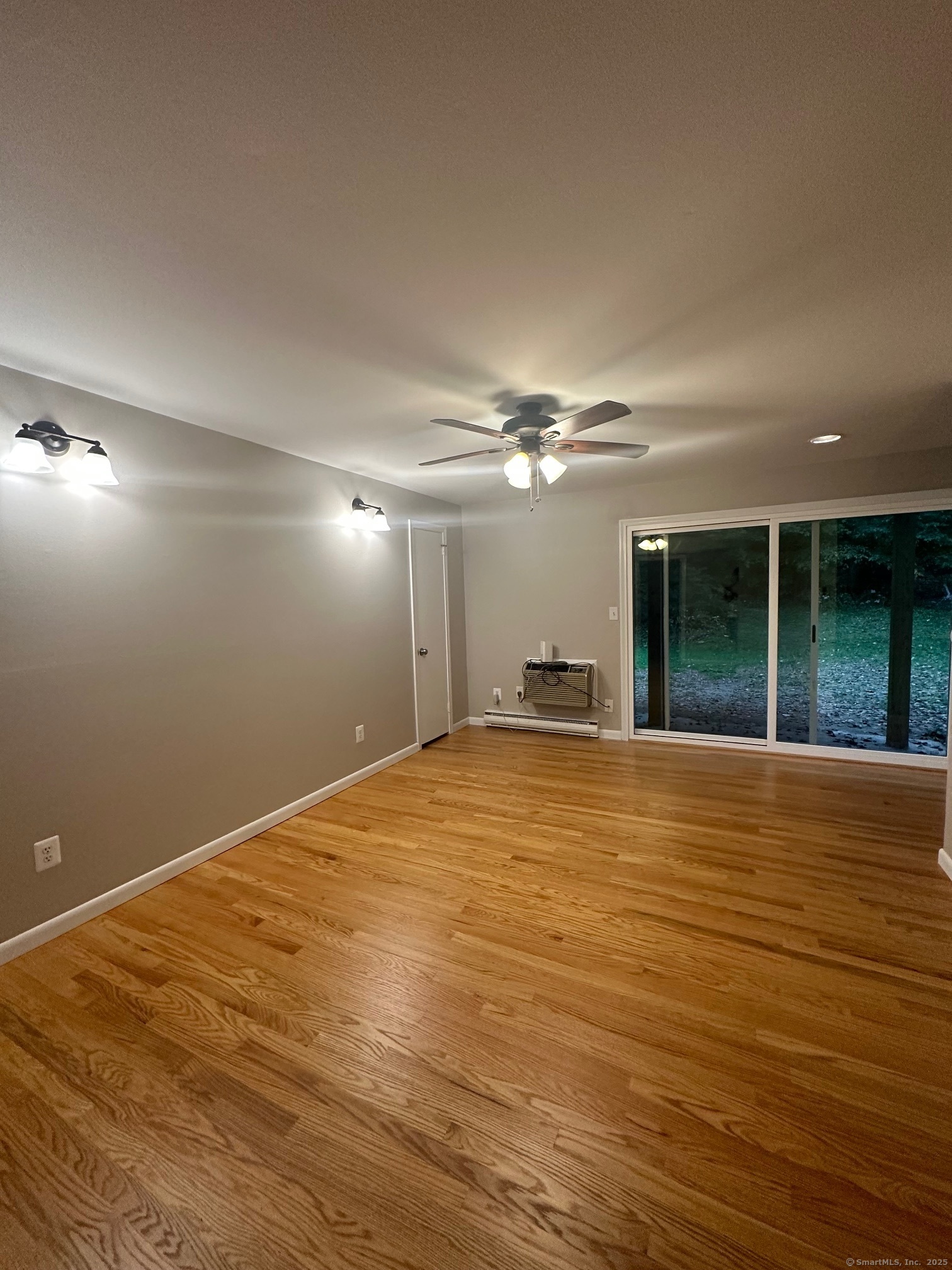 1622 Farmington Avenue, Unit 1 Farmington, CT 06085 - Photo 2 of 8 a view of empty room with wooden floor and fan