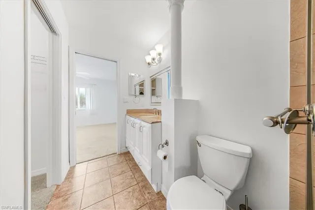 a white toilet sitting next to a bathroom sink