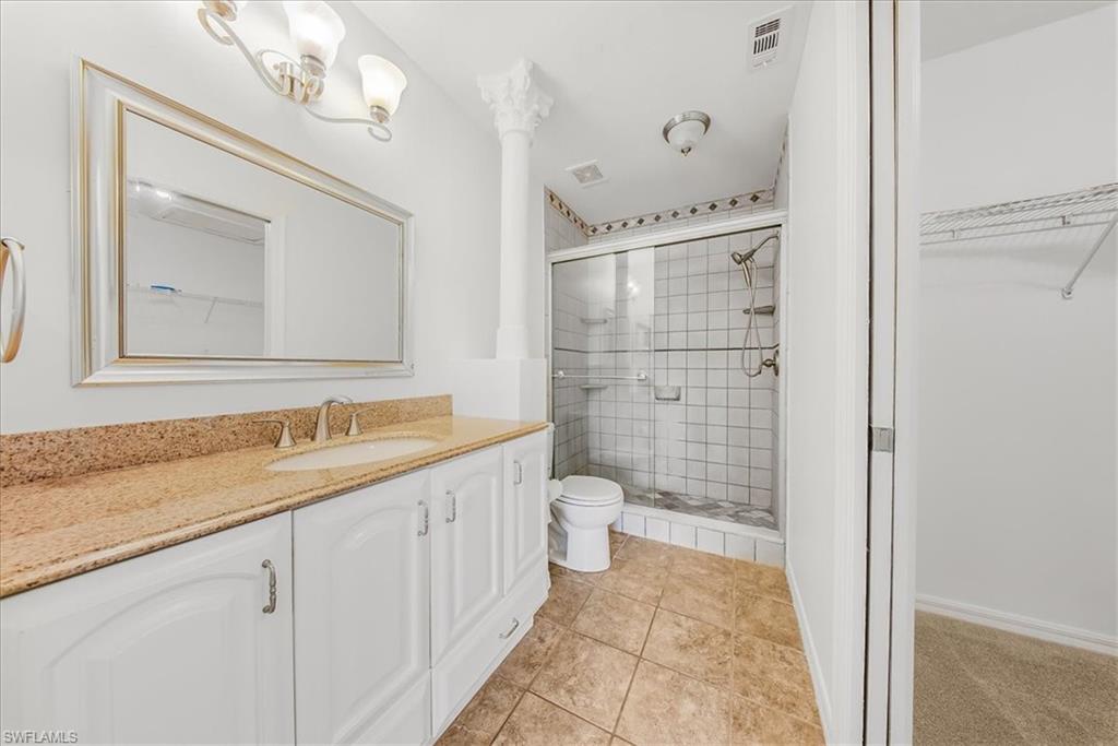 230 Timber Lake Circle, Unit C204 Naples, FL 34104 - Photo 14 of 30 a bathroom with a granite countertop sink mirror and a