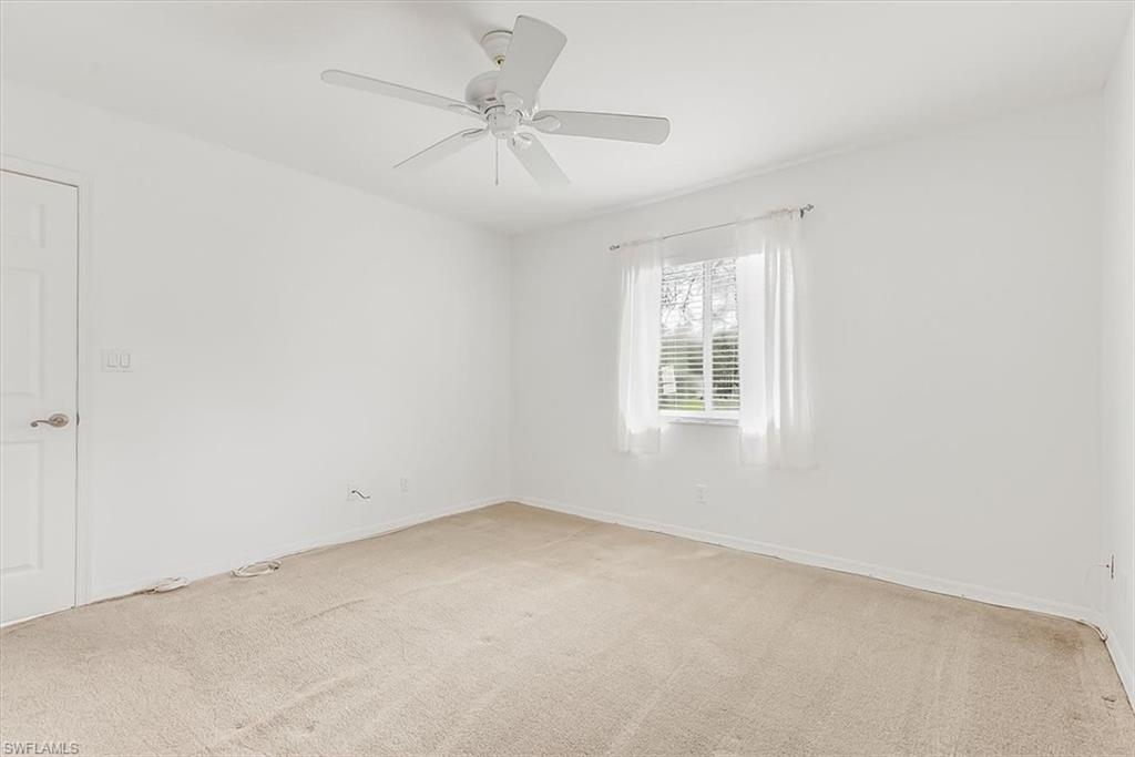 230 Timber Lake Circle, Unit C204 Naples, FL 34104 - Photo 15 of 30 an empty room with a window and a fan