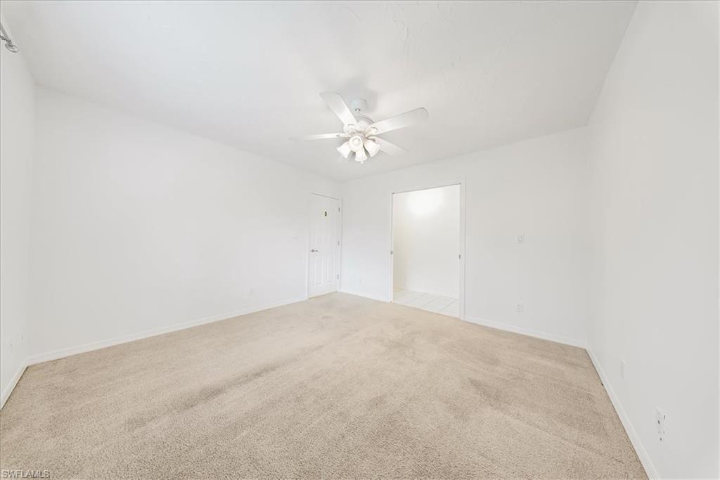 230 Timber Lake Circle, Unit C204 Naples, FL 34104 - Photo 17 of 30 an empty room with a ceiling fan and a window