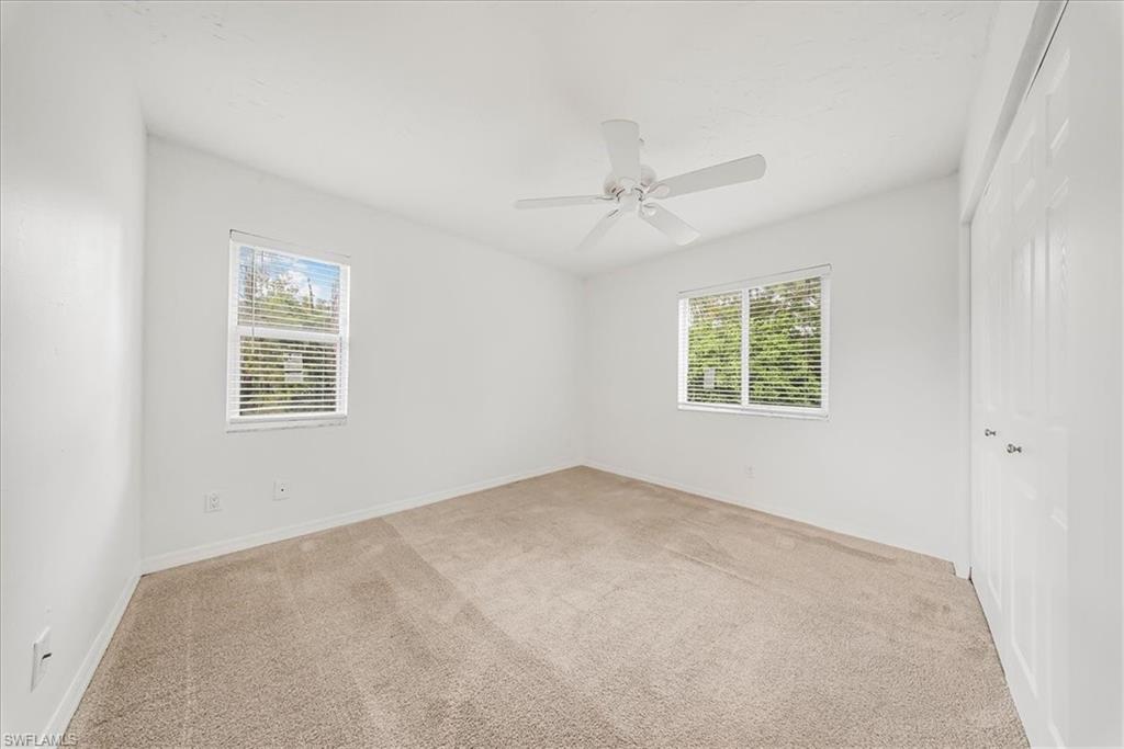 230 Timber Lake Circle, Unit C204 Naples, FL 34104 - Photo 21 of 30 an empty room with a window