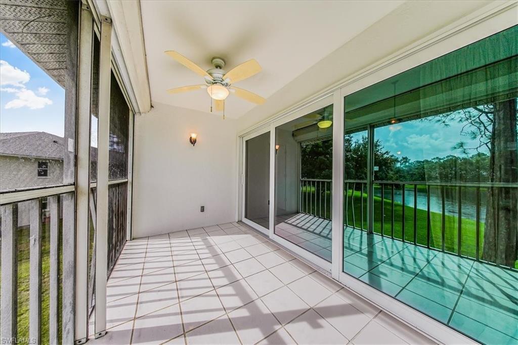 230 Timber Lake Circle, Unit C204 Naples, FL 34104 - Photo 23 of 30 a view of a balcony with floor to ceiling windows with wooden floor
