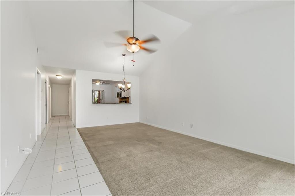 230 Timber Lake Circle, Unit C204 Naples, FL 34104 - Photo 3 of 30 a view of a room with a chandelier fan and windows