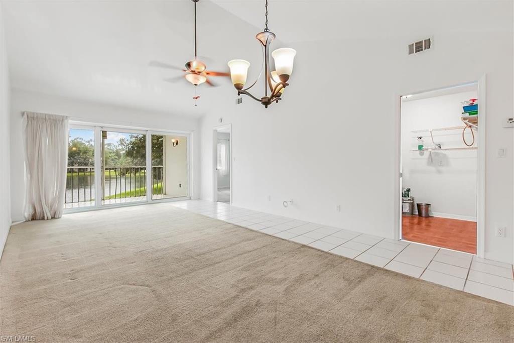 230 Timber Lake Circle, Unit C204 Naples, FL 34104 - Photo 5 of 30 a view of a livingroom with a chandelier fan and windows