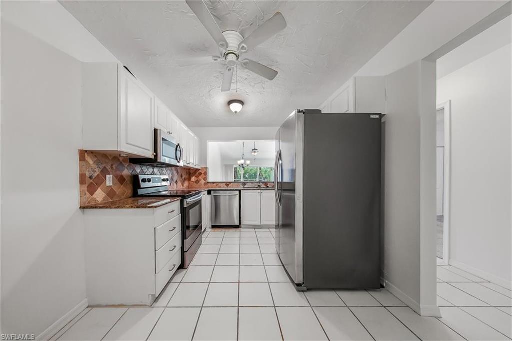 230 Timber Lake Circle, Unit C204 Naples, FL 34104 - Photo 8 of 30 a kitchen with stainless steel appliances a refrigerator and a stove