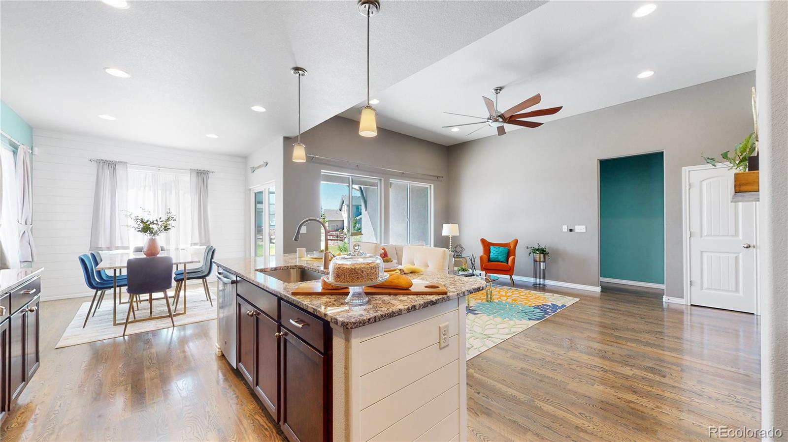 12449 Carmel Ridge Road Colorado Springs, CO 80921 - Photo 12 of 40 a living room with stainless steel appliances granite countertop furniture a couch and a chandelier