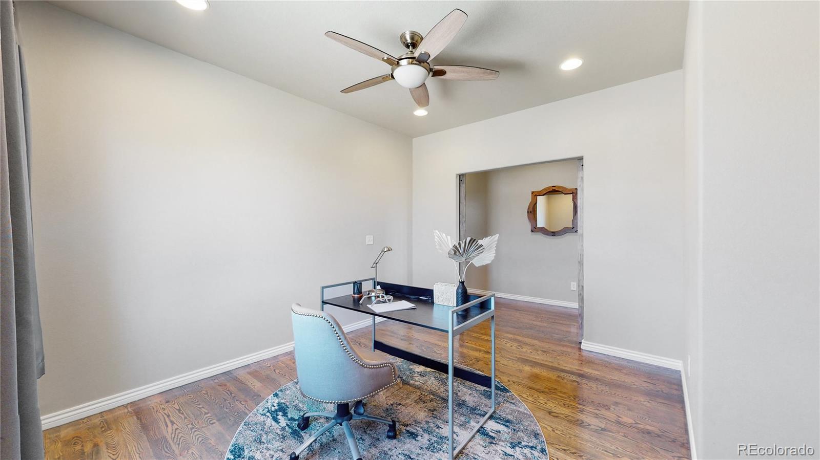 12449 Carmel Ridge Road Colorado Springs, CO 80921 - Photo 16 of 40 a living room with couch and a table