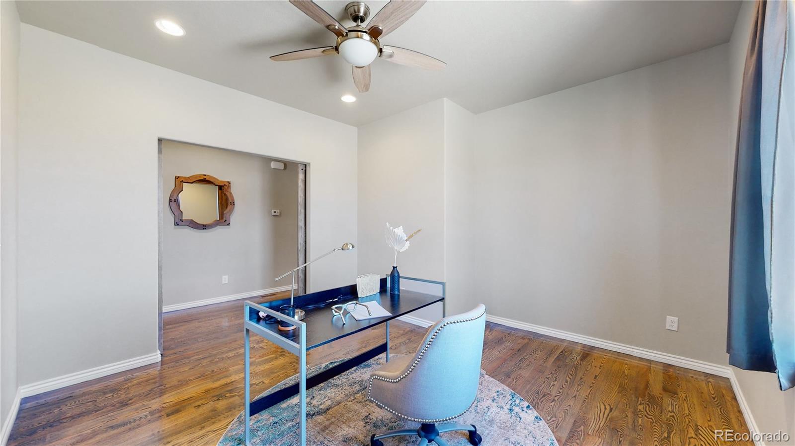 12449 Carmel Ridge Road Colorado Springs, CO 80921 - Photo 17 of 40 a living room with wooden floor and ceiling fan