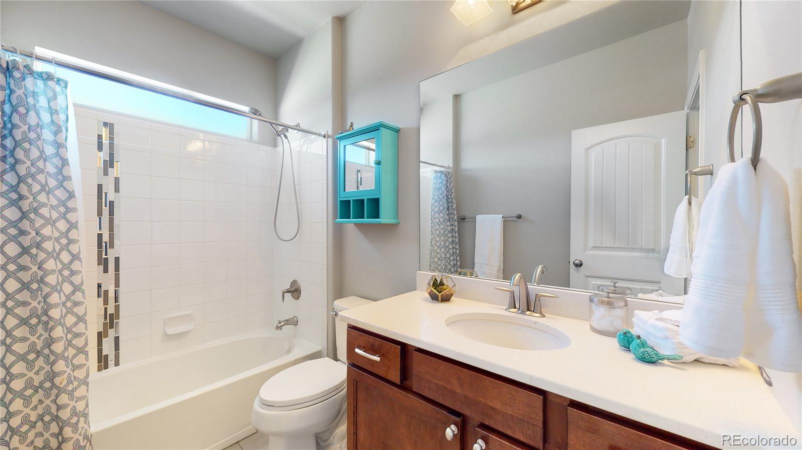 12449 Carmel Ridge Road Colorado Springs, CO 80921 - Photo 18 of 40 a bathroom with a granite countertop sink toilet and shower