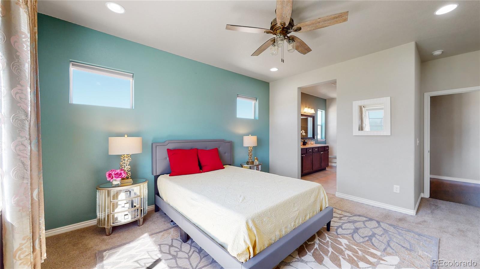 12449 Carmel Ridge Road Colorado Springs, CO 80921 - Photo 22 of 40 a bedroom with a bed and a chandelier