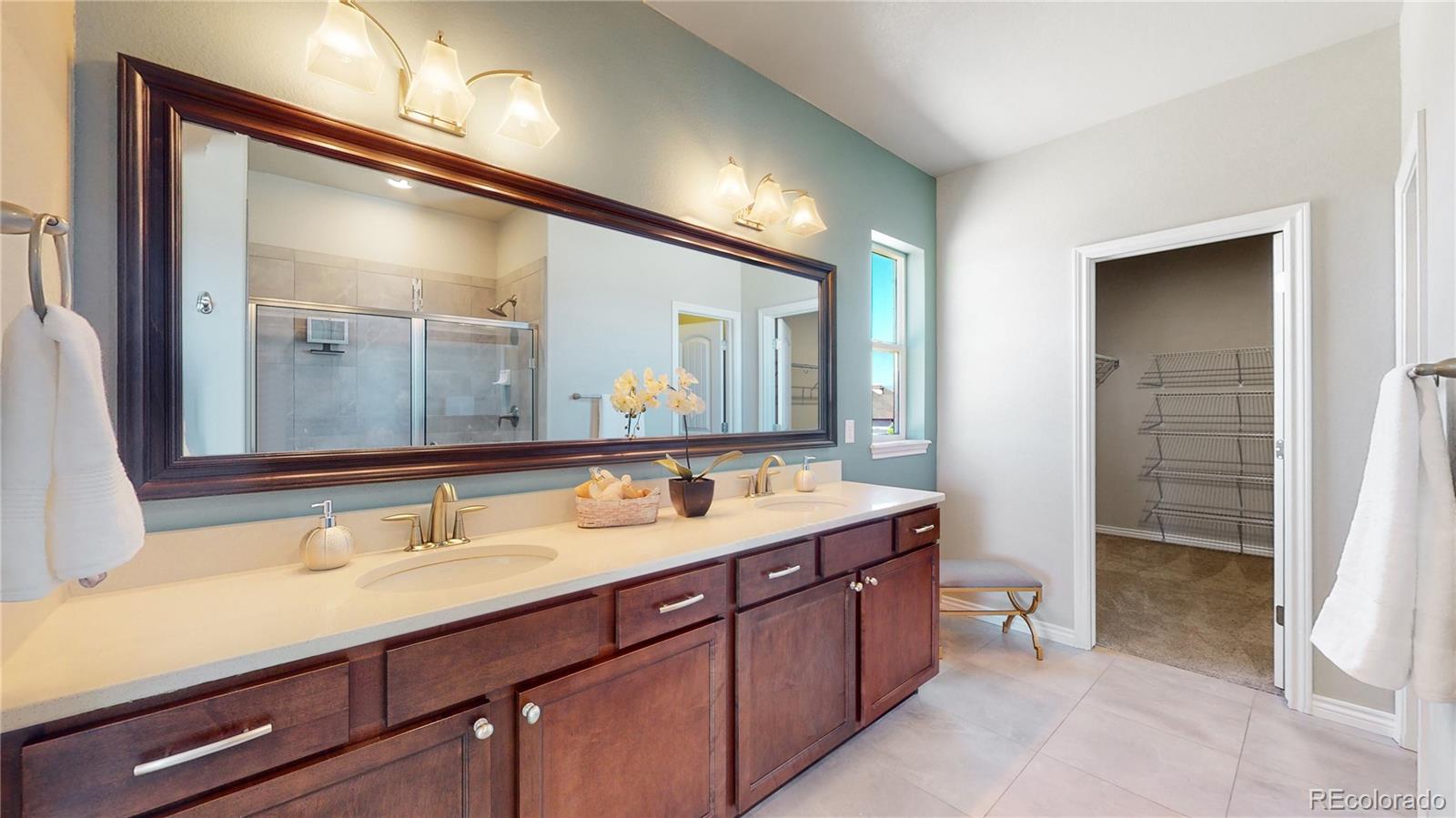 12449 Carmel Ridge Road Colorado Springs, CO 80921 - Photo 23 of 40 a bathroom with a sink and a mirror