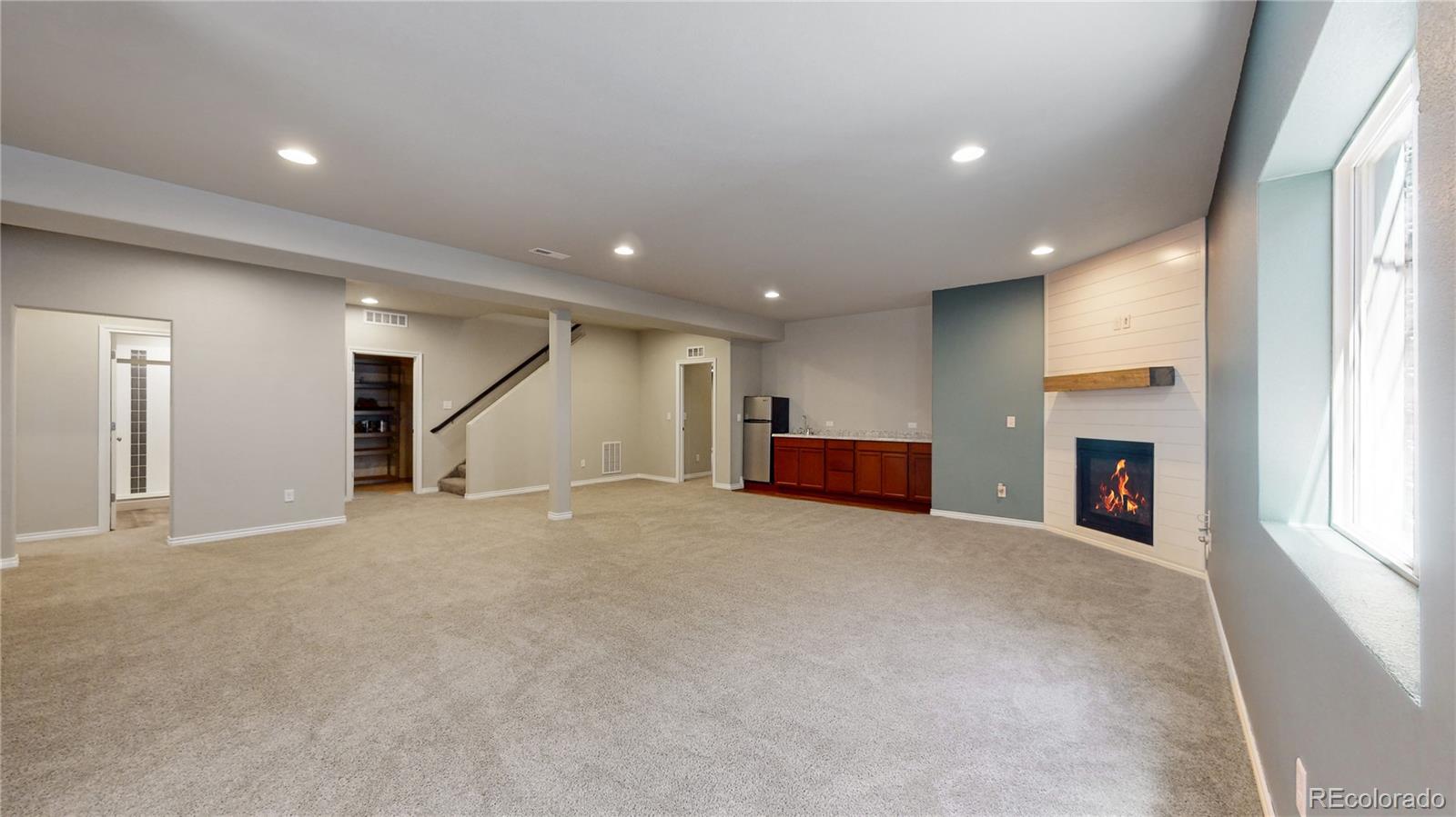 12449 Carmel Ridge Road Colorado Springs, CO 80921 - Photo 28 of 40 an empty room with fireplace and windows