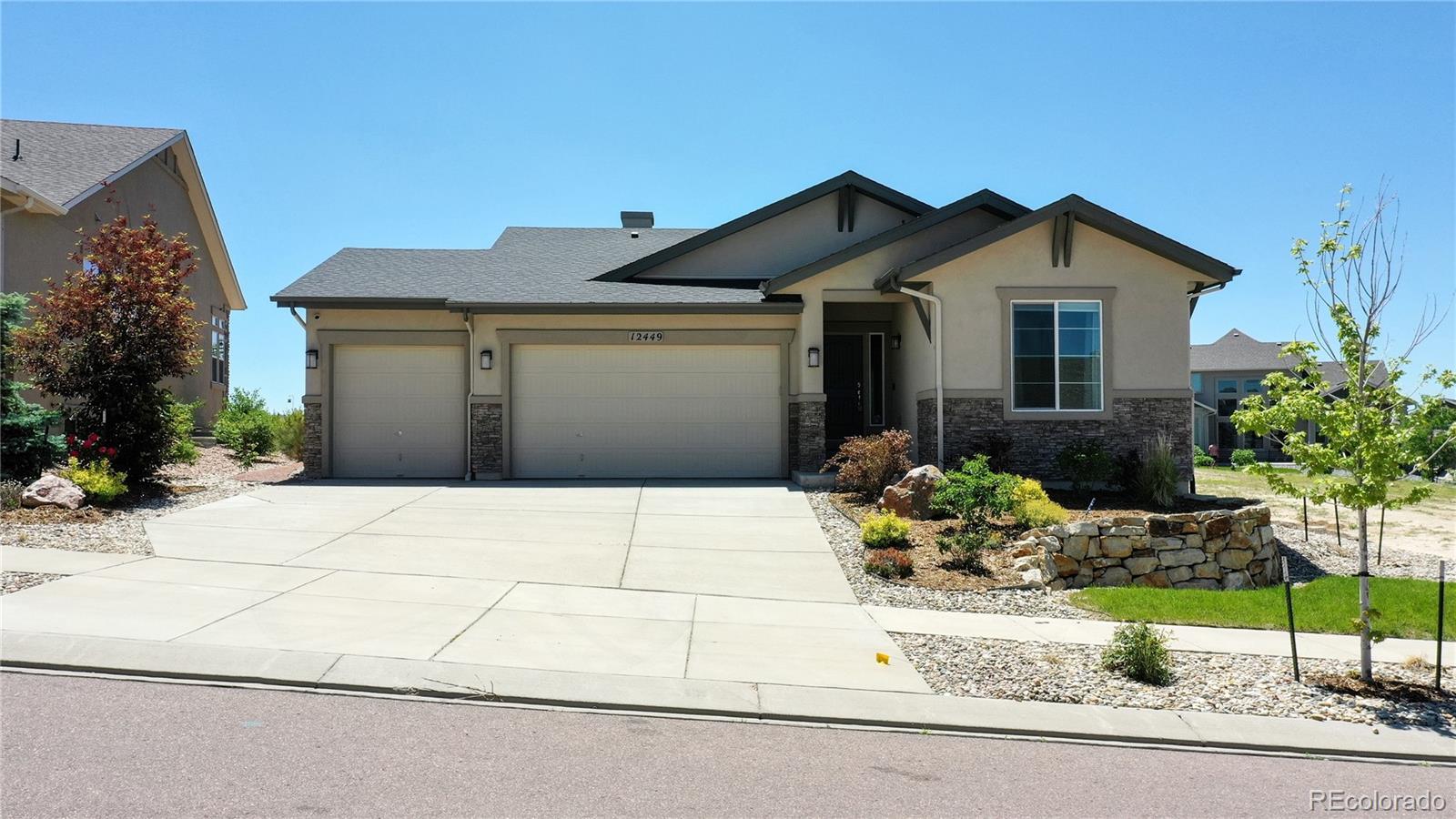 12449 Carmel Ridge Road Colorado Springs, CO 80921 - Photo 40 of 40 a front view of a house with a yard and garage