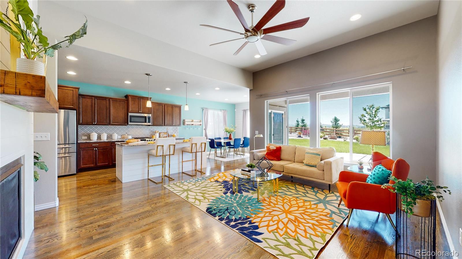 12449 Carmel Ridge Road Colorado Springs, CO 80921 - Photo 4 of 40 a living room with stainless steel appliances kitchen island granite countertop furniture and a kitchen view