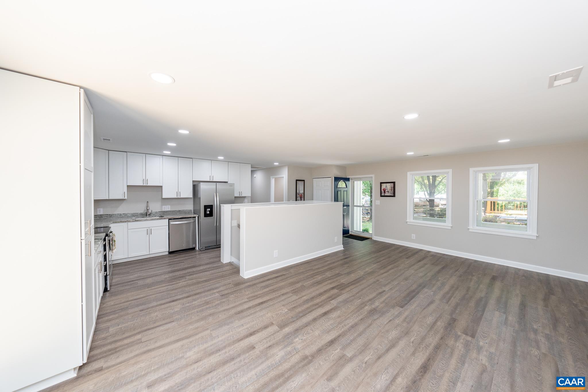 1861 Woodburn Road Charlottesville, VA 22901 - Photo 16 of 42 a view of a kitchen with wooden floor and windows