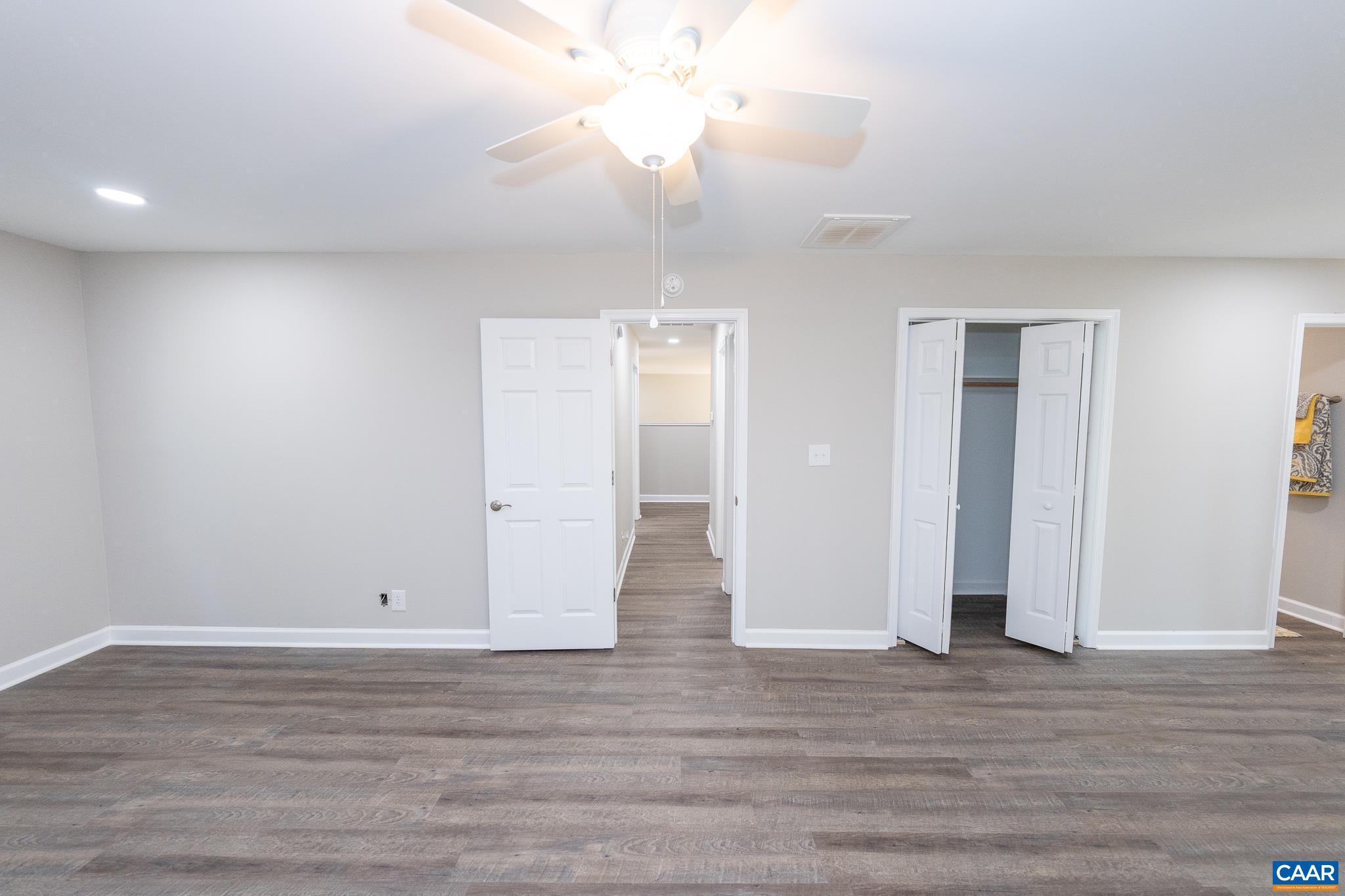 1861 Woodburn Road Charlottesville, VA 22901 - Photo 23 of 42 a view of room with wooden floor and ceiling fan