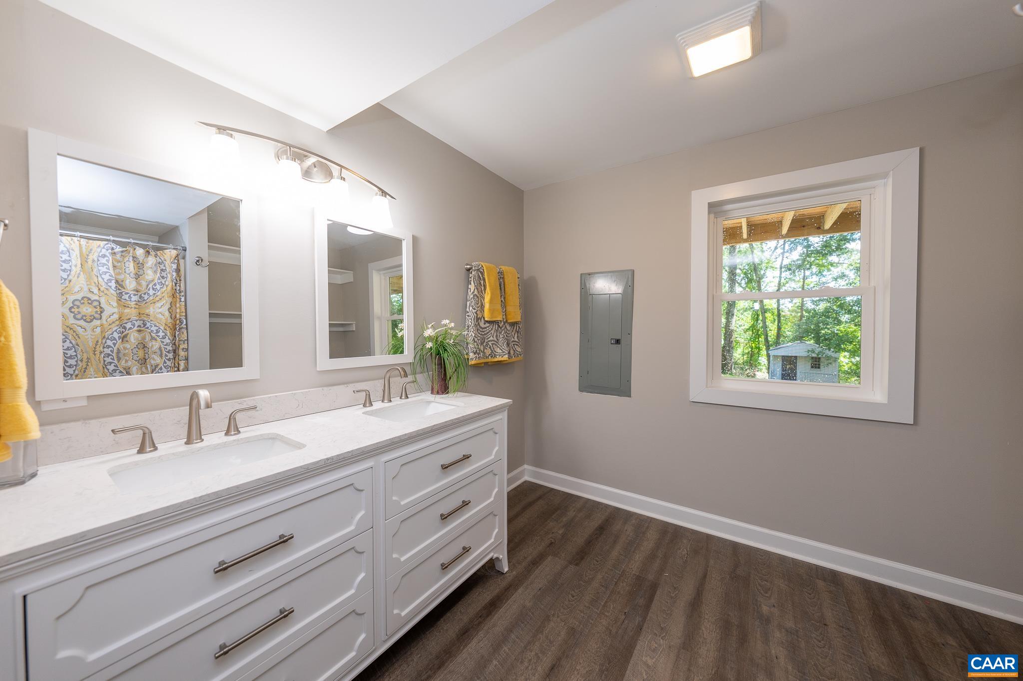 1861 Woodburn Road Charlottesville, VA 22901 - Photo 30 of 42 a bathroom with a double vanity sink and mirror with window