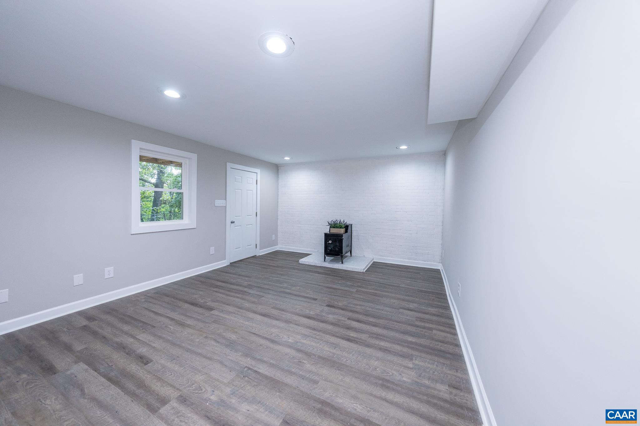 1861 Woodburn Road Charlottesville, VA 22901 - Photo 33 of 42 a view of an empty room with wooden floor and a window