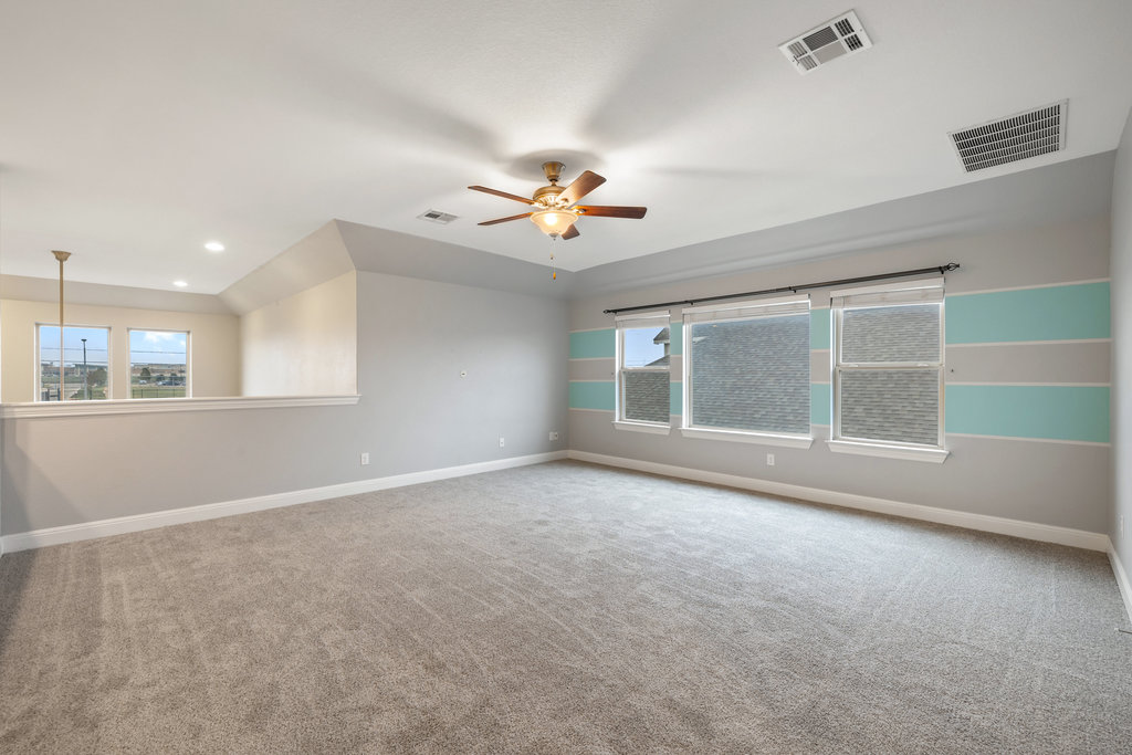 5208 Anaheim Avenue Pflugerville, TX 78660 - Photo 25 of 38 a view of an empty room with a window and a kitchen