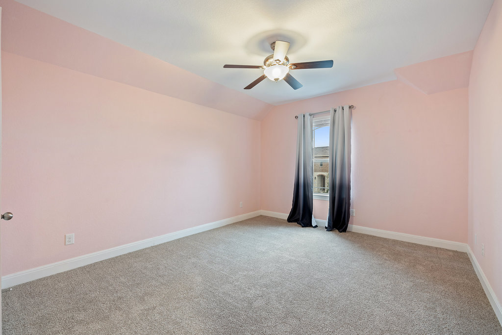 5208 Anaheim Avenue Pflugerville, TX 78660 - Photo 27 of 38 a view of an empty room with a chandelier fan