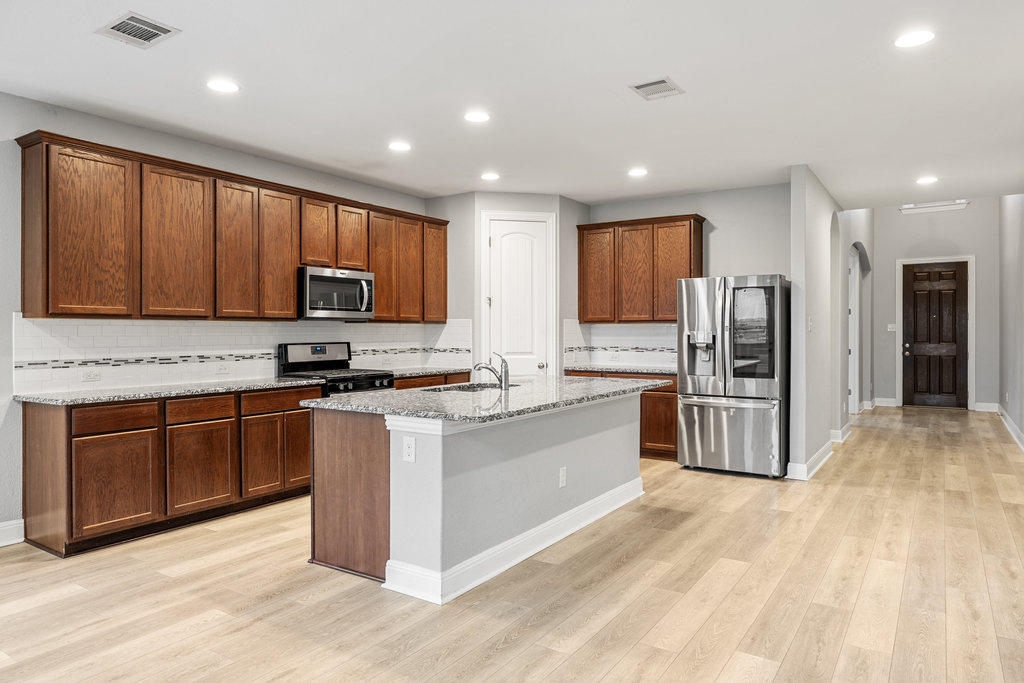 5208 Anaheim Avenue Pflugerville, TX 78660 - Photo 10 of 38 a large kitchen with stainless steel appliances lots of counter top space