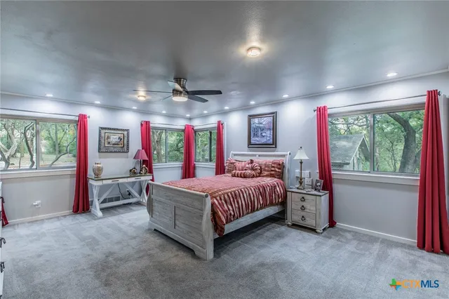 a bed room with a bed and a large window