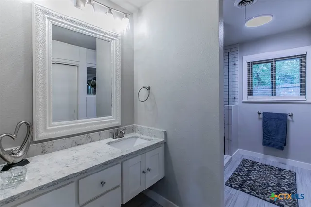 a bathroom with a sink and a mirror